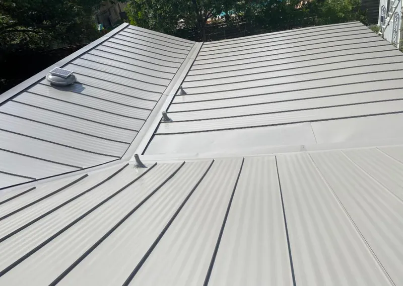 Solar attic fan installed on a metal roof for Roof Ventilation in Sugar Hill